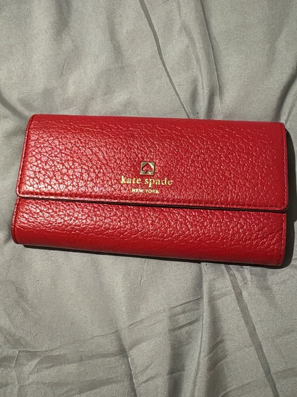 kate spade red pebbled leather continental wallet with gold logo